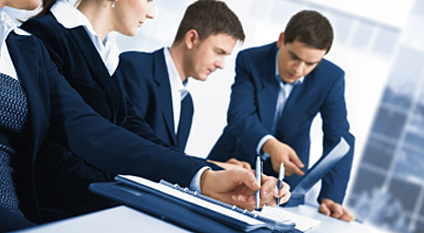 group of men looking at laptop